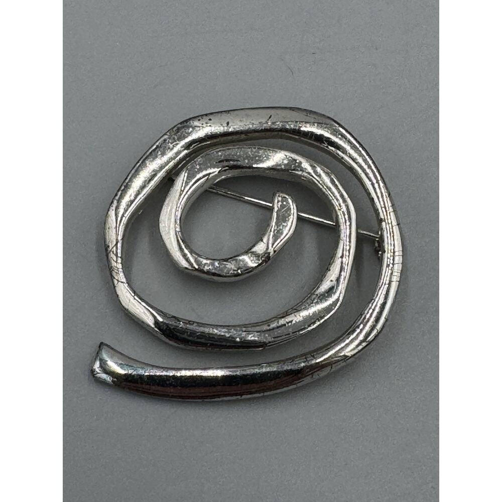 Silver Colored Circular Spiral Shaped Brooch Marked AK